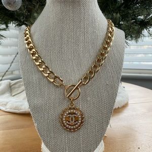 Authentic Chanel button used to create a necklace. Chain is 18 inches long.